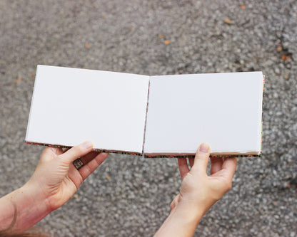 open sketchbook held by two hands