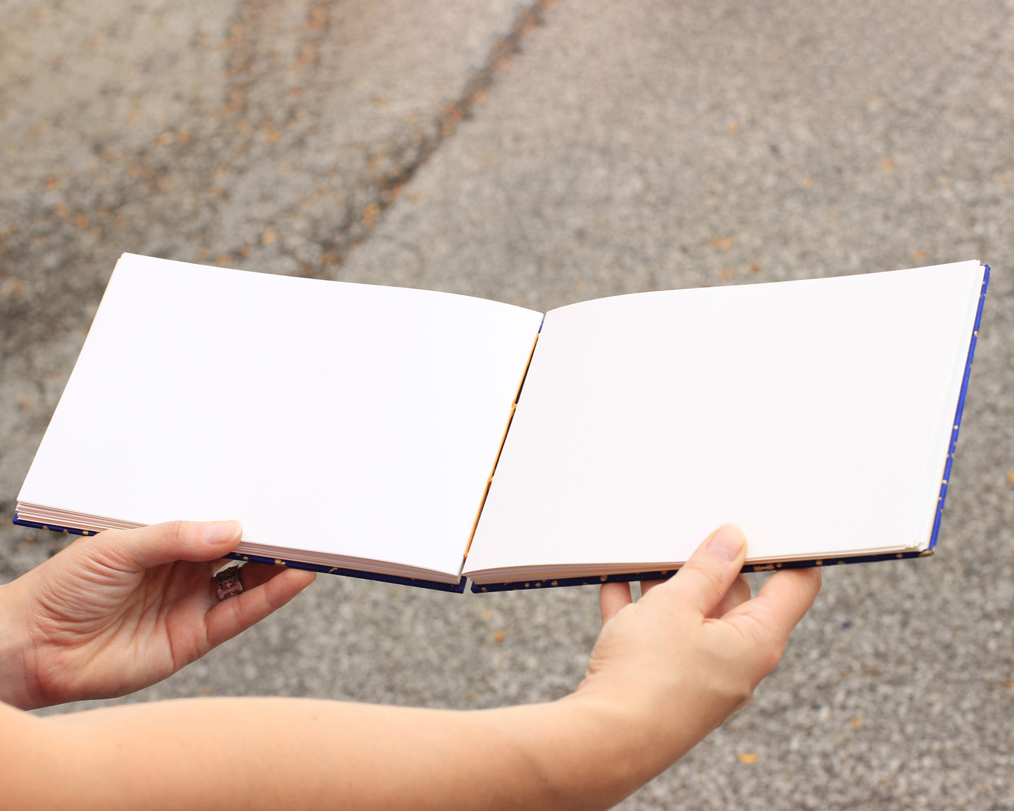hands holding sketchbook open